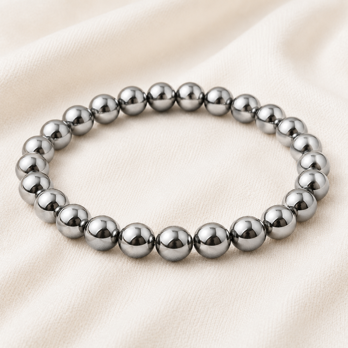 Silver Hematite Bracelet displayed fully on white silk cloth to show its natural colour, shape and finish