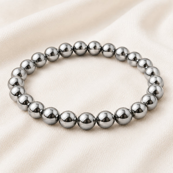 Silver Hematite Bracelet displayed fully on white silk cloth to show its natural colour, shape and finish