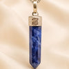 Close-up of authentic natural Sodalite showing crystal texture, colour and craftsmanship – sodalite pencil pendant chain healing crystal for clarity confidence