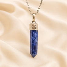 Load image into Gallery viewer, Sodalite Pencil Pendant displayed fully on white silk cloth to show its natural colour, shape and finish
