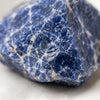 Close-up of authentic natural Sodalite showing crystal texture, colour and craftsmanship – sodalite raw stone symbol of clarity communication and intuition