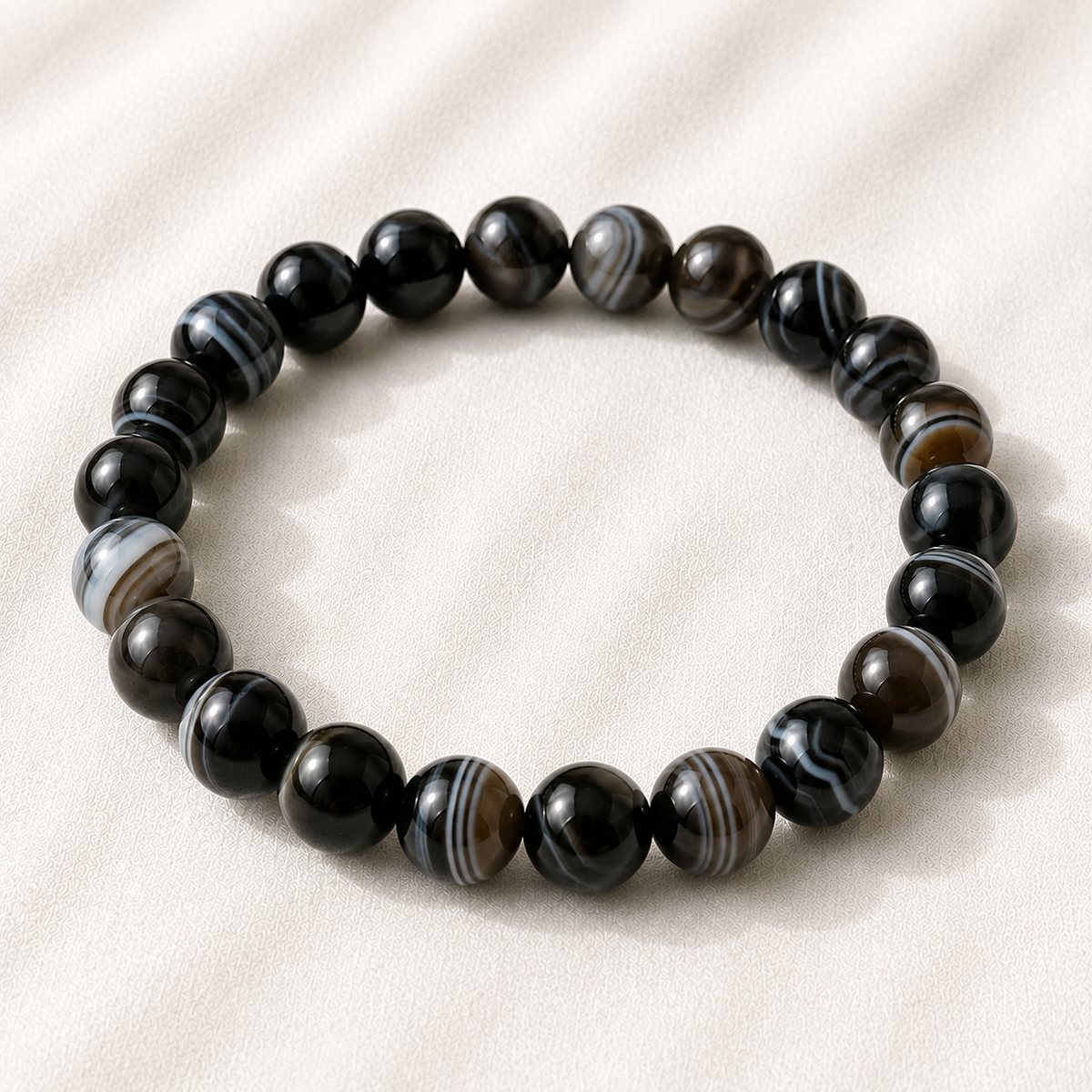 Sulemani Hakik Bracelet displayed fully on white silk cloth to show its natural colour, shape and finish