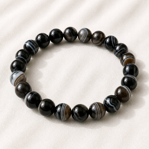 Sulemani Hakik Bracelet displayed fully on white silk cloth to show its natural colour, shape and finish