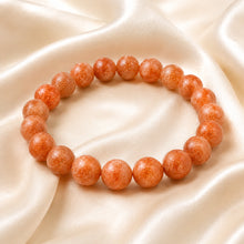 Load image into Gallery viewer, Sunstone Bracelet displayed fully on white silk cloth to show its natural colour, shape and finish
