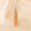 Sunstone Pencil Pendant displayed fully on white silk cloth to show its natural colour, shape and finish