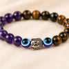 Close-up of authentic natural Tiger Eye, Amethyst and Evil Eye showing crystal texture, colour and craftsmanship