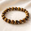 Tiger Eye Bracelet displayed fully on white silk cloth to show its natural colour, shape and finish