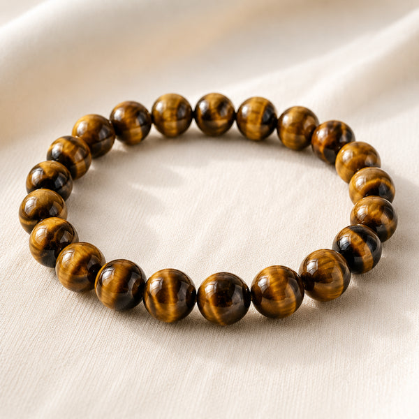 Tiger Eye Bracelet displayed fully on white silk cloth to show its natural colour, shape and finish
