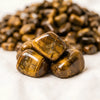Close-up of authentic natural Tiger Eye showing crystal texture, colour and craftsmanship – tiger eye chips stone symbol of courage focus and practicality