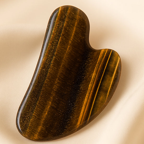 Close-up of authentic natural Tiger Eye showing crystal texture, colour and craftsmanship – tiger eye gua sha symbol of courage focus and practicality