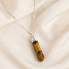 Close-up of authentic natural Tiger Eye showing crystal texture, colour and craftsmanship – tiger eye pencil pendant with chain helps in protection confidence