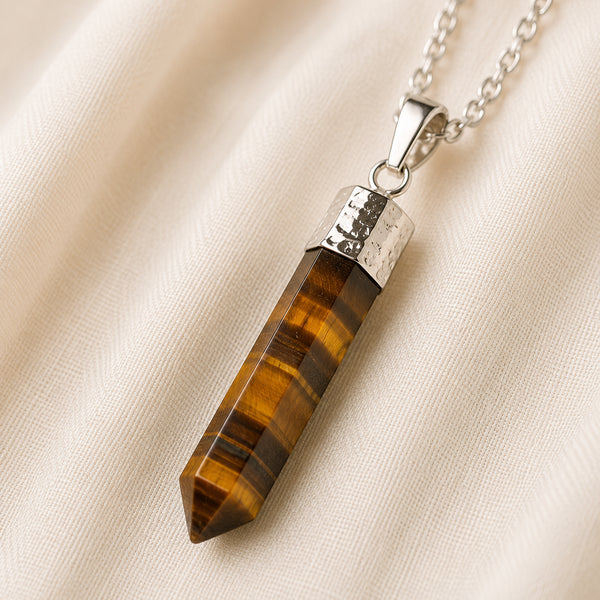 Tiger Eye Pencil Pendant displayed fully on white silk cloth to show its natural colour, shape and finish