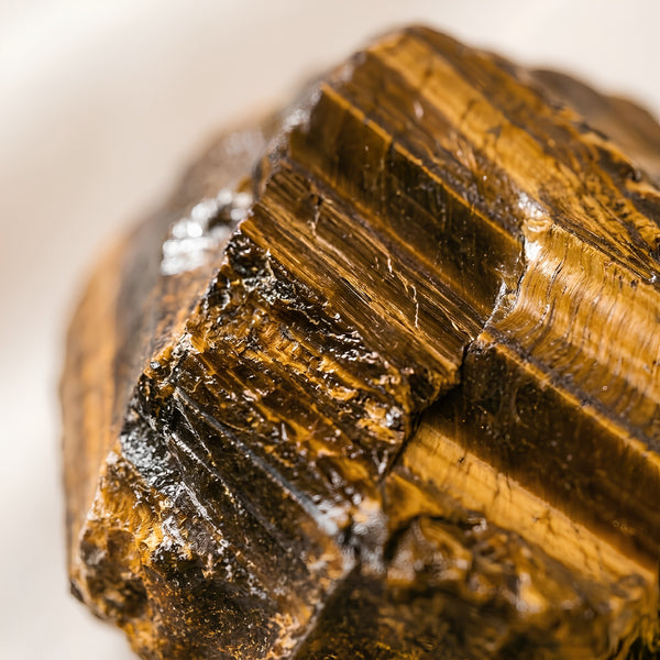 Close-up of authentic natural Tiger Eye showing crystal texture, colour and craftsmanship – tiger eye raw stone symbol of courage focus and practicality