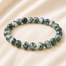 Load image into Gallery viewer, Agate Bracelet displayed fully on white silk cloth to show its natural colour, shape and finish
