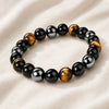 Close-up of authentic natural Black Obsidian, Tiger Eye and Hematite showing crystal texture, colour and craftsmanship – triple protection bracelet for strength