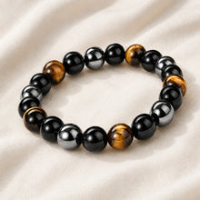 Load image into Gallery viewer, Close-up of authentic natural Black Obsidian, Tiger Eye and Hematite showing crystal texture, colour and craftsmanship – triple protection bracelet for strength
