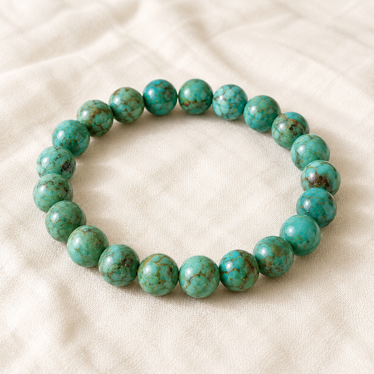 Turquoise Green Bracelet displayed fully on white silk cloth to show its natural colour, shape and finish