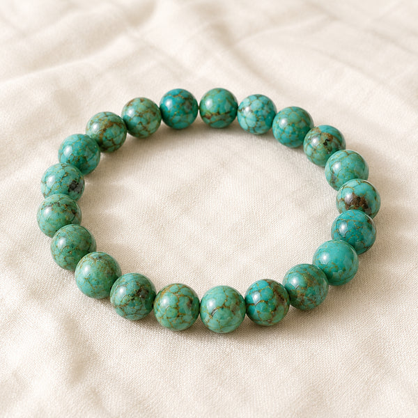 Turquoise Green Bracelet displayed fully on white silk cloth to show its natural colour, shape and finish