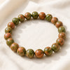 Unakite Bracelet displayed fully on white silk cloth to show its natural colour, shape and finish