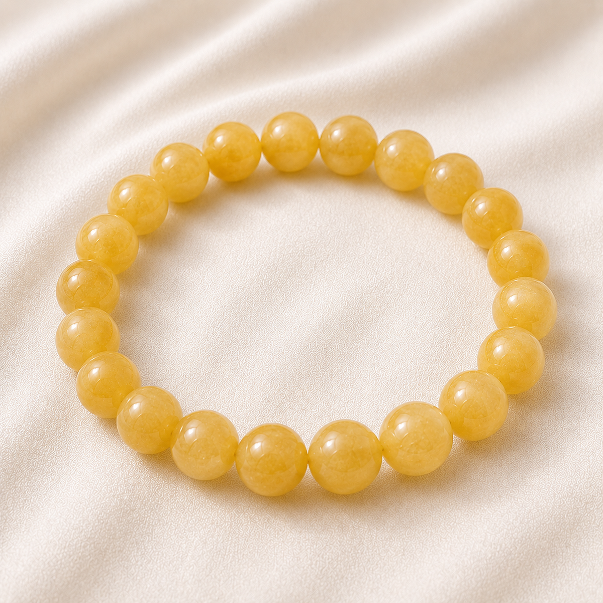 Yellow Aventurine Bracelet displayed fully on white silk cloth to show its natural colour, shape and finish