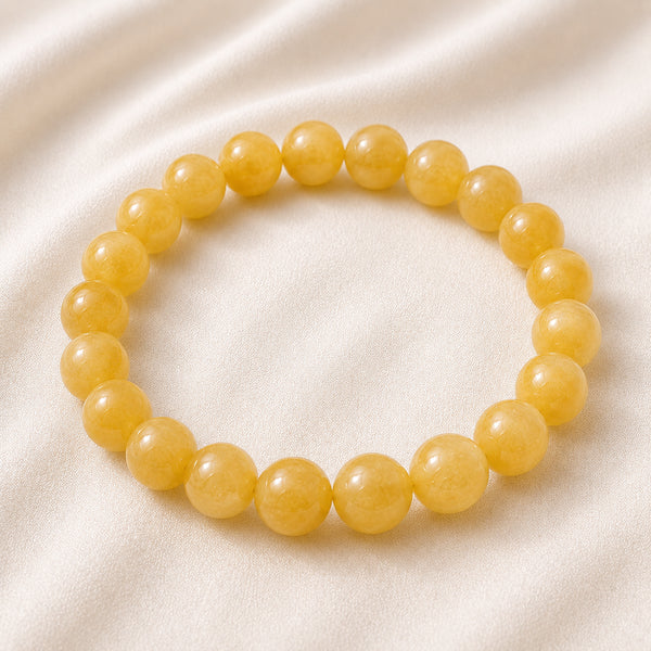 Yellow Aventurine Bracelet displayed fully on white silk cloth to show its natural colour, shape and finish