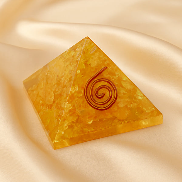 Citrine Orgone Pyramid displayed fully on white silk cloth to show its natural colour, shape and finish