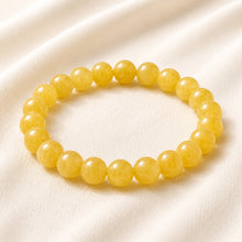 Load image into Gallery viewer, Yellow Jade Bracelet displayed fully on white silk cloth to show its natural colour, shape and finish
