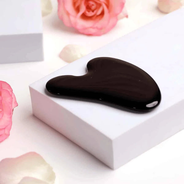 Black Obsidian Gua Sha tool for face care, used for tension release, cleansing effects and skin protection.