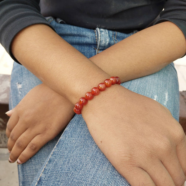 Lifestyle shot of a Carnelian bracelet on a person's wrist, emphasizing comfort and beauty.