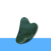 Green Jade facial Gua Sha tool shown clearly, supporting skin renewal, cooling effect, and prosperity energy.