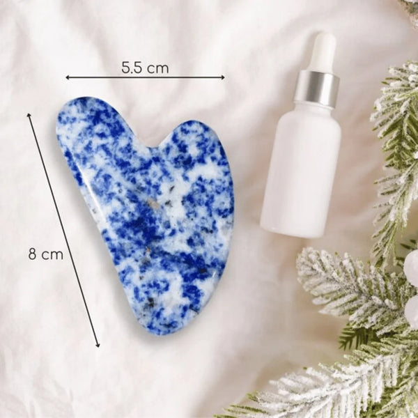 Sodalite crystal Gua Sha tool for face care, offering relaxation, mental focus and expressive skin support.