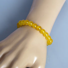 Load image into Gallery viewer, A collection of Yellow Jade bracelet showcasing different styles and sizes along with their Yellow Jade bracelet benefits.
