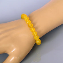 Load image into Gallery viewer, Lifestyle shot of a Yellow Jade bracelet on a person&#39;s wrist, emphasizing comfort and beauty.
