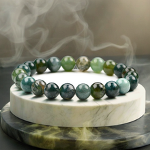 Load image into Gallery viewer, Model wearing a stylish Moss Agate bracelet to highlight its elegance and aesthetic appeal. Get to know more about the Moss Agate benefits
