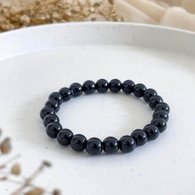 Load image into Gallery viewer, The Black Onyx bracelet with a focus on its vibrant color and unique texture.
