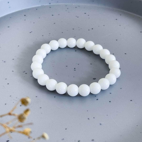 Lifestyle shot of a White Agate bracelet on a person's wrist, emphasizing comfort and beauty.