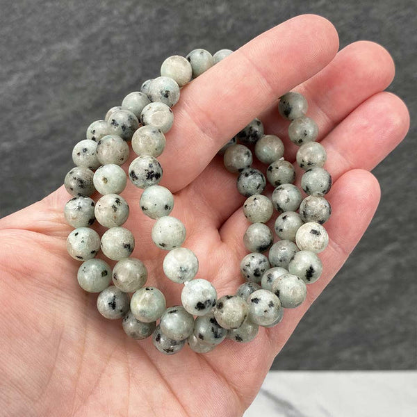 A collection of Kiwi Jasper bracelet showcasing different styles and sizes along with their Kiwi Jasper bracelet benefits.