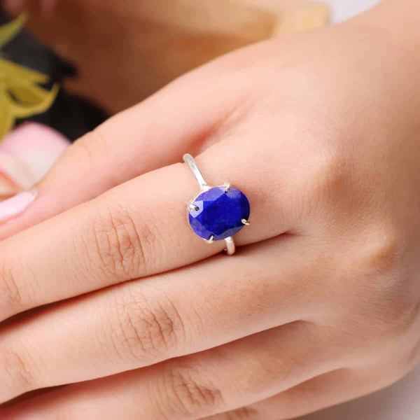 Diamond-cut Lapis Lazuli gemstone ring showcased on a finger, highlighting its faceted finish and elegant band.