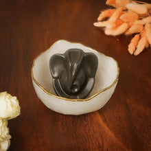 Load image into Gallery viewer, Lord Ganesha decorative showpiece in a white bowl, placed on a wooden table for spiritual home décor.
