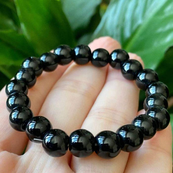 Lifestyle shot of a Black Obsidian bracelet on a person's wrist, emphasizing comfort and beauty.