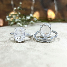Load image into Gallery viewer, Pair of clear crystal adjustable rings placed together, showcasing a simple and elegant minimalist jewelry style.
