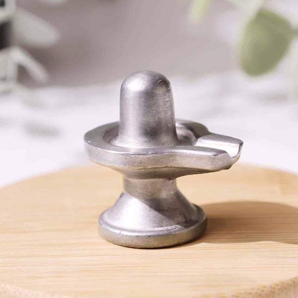 Realistic photo of a Parad Mercury Shivling with polished silver shine on a clean backdrop.