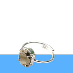 Pyrite adjustable diamond cut ring on a clean white and blue minimalist background, symbolizing willpower and fortune.
