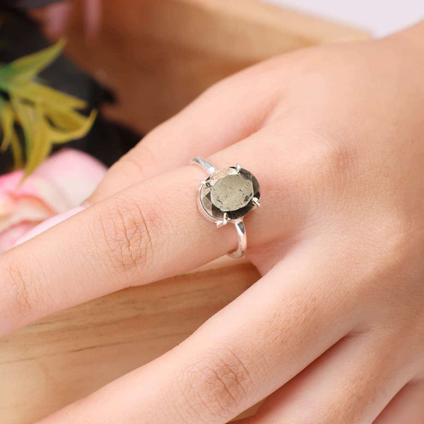 Pyrite diamond cut adjustable ring worn on finger, representing willpower, action and good fortune.