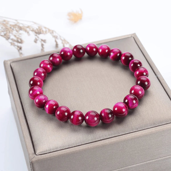 Red bead bracelet placed on a pink box.