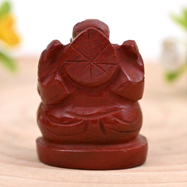 Back shot of Red Jasper Ganesh crystal figurine in natural light, showing detailed carving for strength, success and protection.