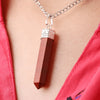 Red Jasper pencil pendant with a silver chain worn around the neck