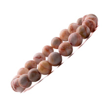 Load image into Gallery viewer, Model wearing a stylish Red Picasso Jasper bracelet to highlight its elegance and aesthetic appeal. Get to know more about the Red Picasso Jasper benefits

