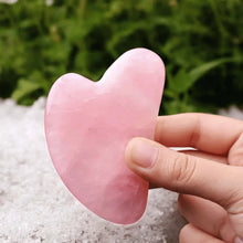 Load image into Gallery viewer, Rose Quartz Gua Sha face crystal held in hand, promoting love, smooth skin, and radiant glow
