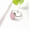 Rose Quartz diamond cut oval ring placed on a white table, promoting love, harmony, emotional healing and protection from negativity.